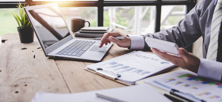 Closeup of a financial advisor creating a tax plan for a client.