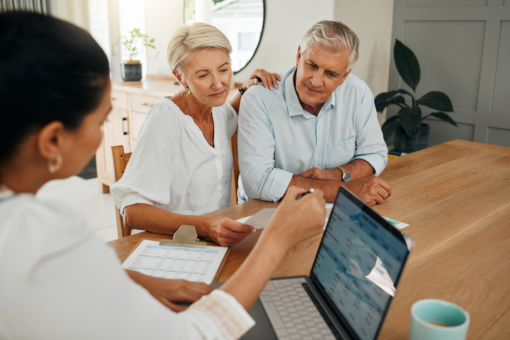 A couple meeting with a financial advisor to discuss an annuity.